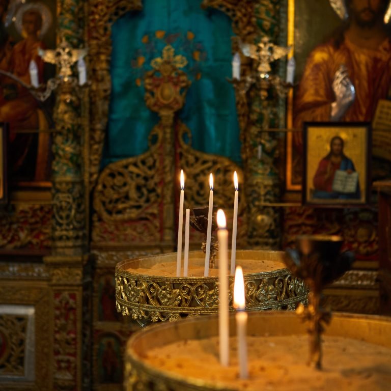 Jerusalem, Israel - July 10, 2019: Many church candles burn in the dark. Candles in the Church in Jerusalem.